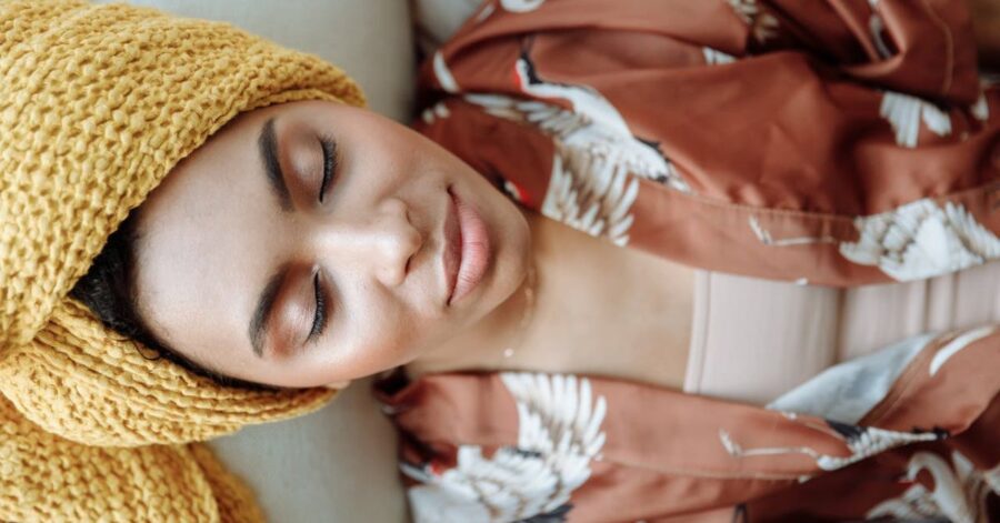 woman relaxing on couch with eyes closed