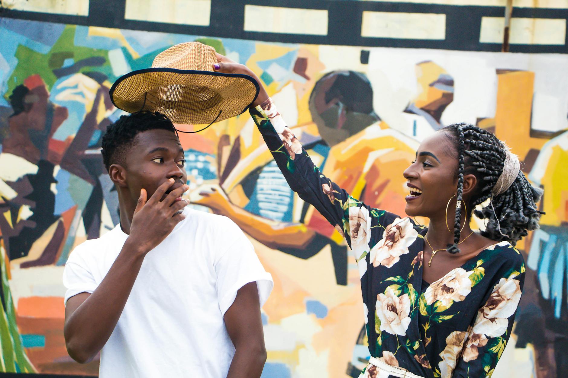 woman holding man s hat