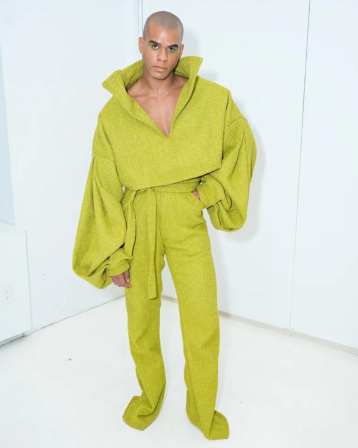 Model in a two-piece green set designed by Joseph McRae.